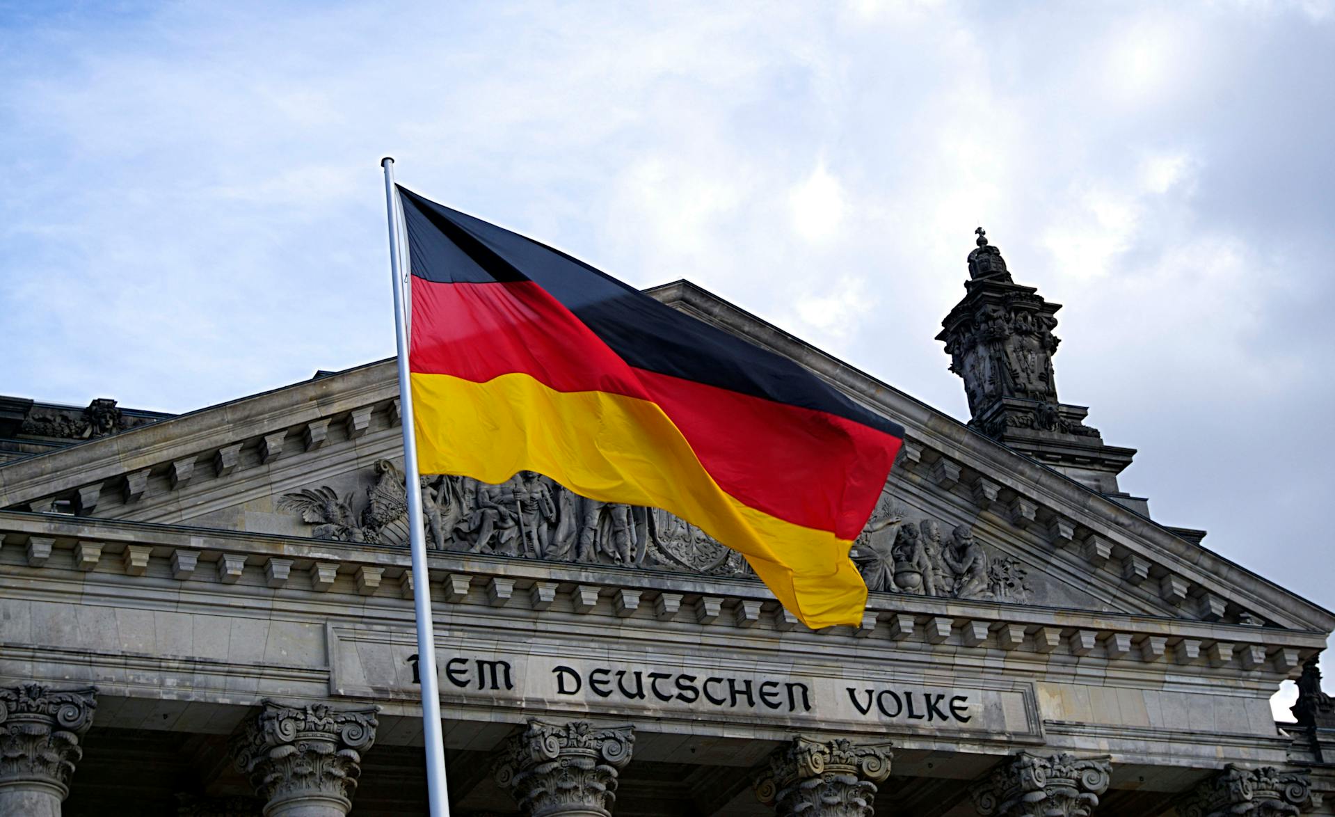 The German flag flies outside the Reichstag building